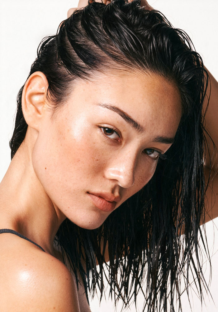 Vått hår som gres med kam for å fordele pleieprodukt i hodebunnen